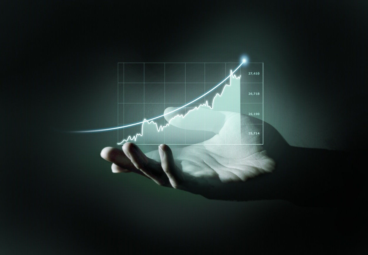 Hand holding a graph showing a rising line, symbolizing growth and success